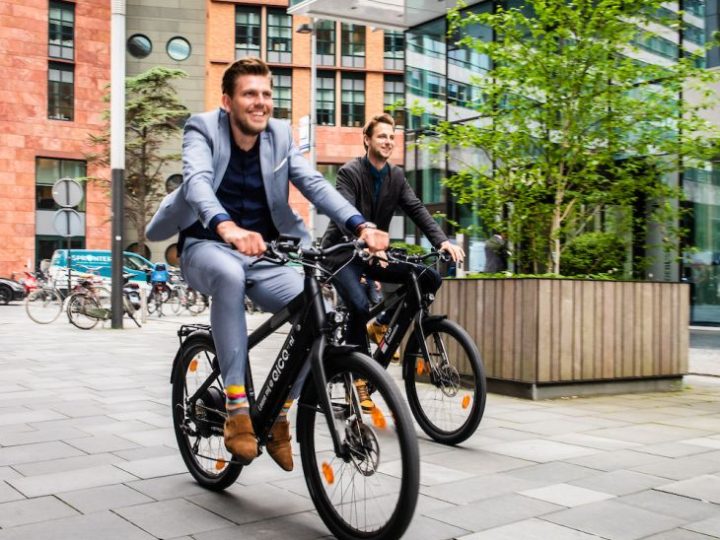 Twee Accenture-medewerkers testen de e-bike vast uit, met op links mobiliteitsmanager Coen Krol.